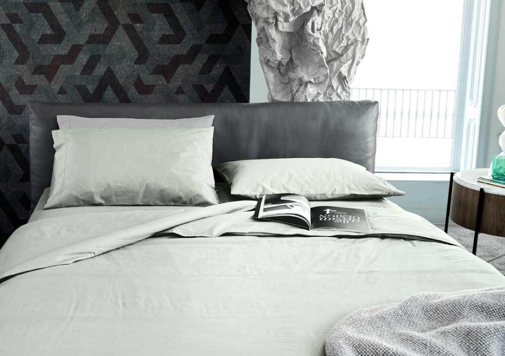 Matching 100%, Stone Washed Yoko green cotton sheets and Soho bed in grey leather