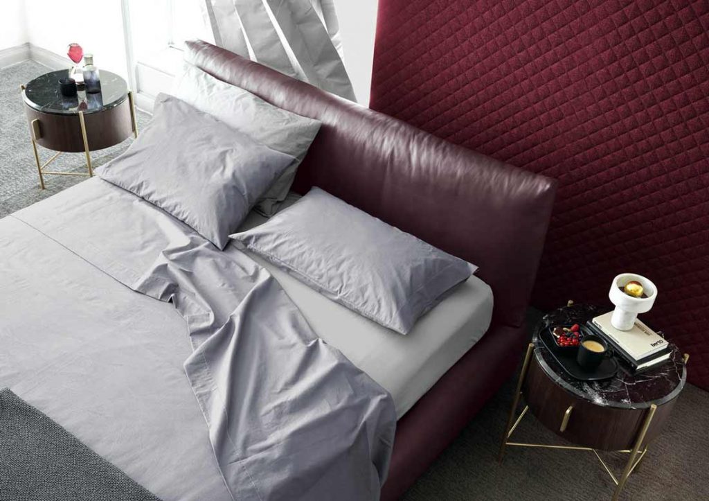 Grey Yoko cotton sheet set elegantly dresses the Soho bed in leather